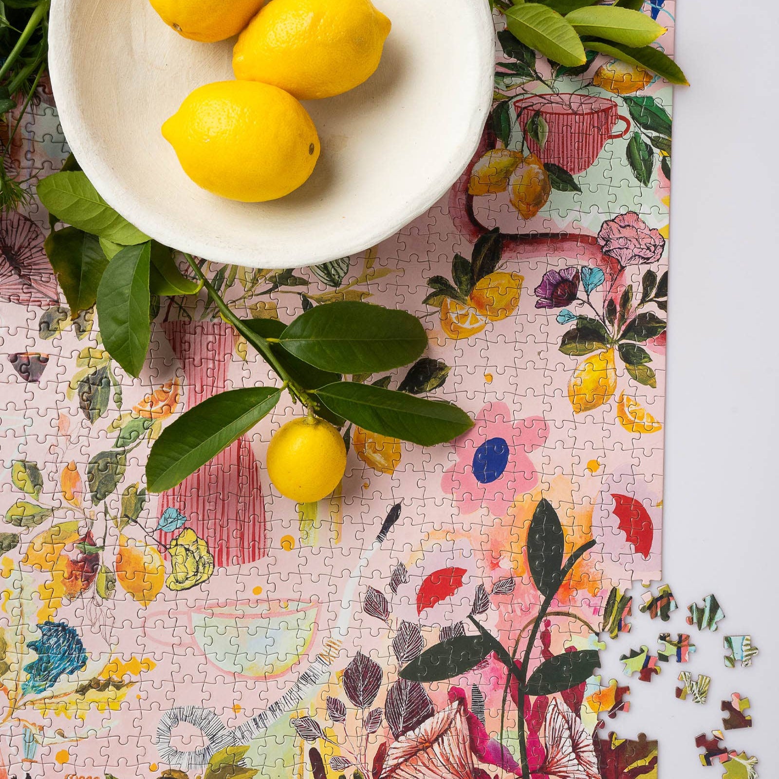 Colorful puzzle with lemons and leaves on a floral-patterned surface