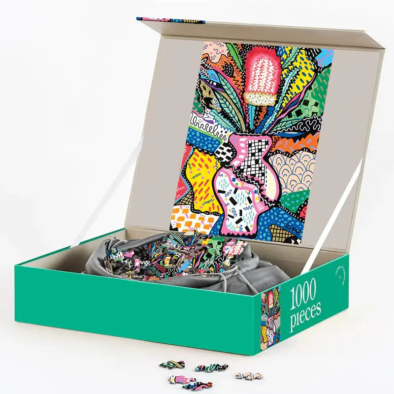 Colorful puzzle with pieces spilling out of a box labeled '1000 pieces' on a white background